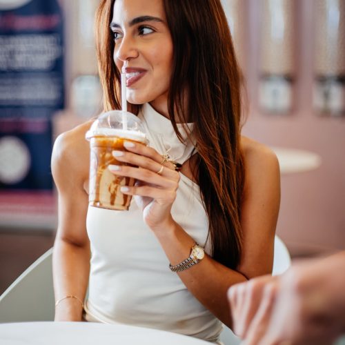 girl-sipping-iced-coffee-smiling